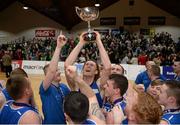 25 January 2015; Andrew Fitzgerald, C&S Blue Demons, celebrates with the cup after the game. Basketball Ireland President's Cup Final, C&S Blue Demons v SSE Airtricity Moycullen. National Basketball Arena, Tallaght, Dublin. Photo by Sportsfile