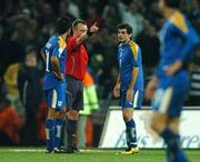 17 October 2007; Referee Mikko Vuorela, Finland, who is refereeing his last game, issues a red card to Marios Ilia, Cyprus, right, as his team-mate Paraskevas Christou watches on. 2008 European Championship Qualifier, Republic of Ireland v Cyprus, Croke Park, Dublin. Picture credit; David Maher / SPORTSFILE