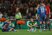 17 October 2007; Robbie Keane, Republic of Ireland, sits on the ground after a challenge by Stelios Okkarides, left, Cyprus. 2008 European Championship Qualifier, Republic of Ireland v Cyprus, Croke Park, Dublin. Picture credit; Brian Lawless / SPORTSFILE