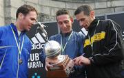 29 October 2007; 1st place men's Irish winner Michael O'Connor, center, from Galway City Harriers views his trophy with 2nd place men's Irish Cian McLoughlin, left, from Clonliffe Harriers Athletic Club and 3rd place men's Irish Gary Crossan from Letterkenny Athletic Club. adidas Dublin City Marathon 2007, Merrion Square, Dublin. Photo by Sportsfile  *** Local Caption ***