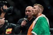 18 January 2015; Conor McGregor is interviewed by UFC commentator Joe Rogan after defeating Dennis Siver in the second round of their bout. UFC Fight Night, Conor McGregor v Dennis Siver, TD Garden, Boston, Massachusetts, USA. Picture credit: Ramsey Cardy / SPORTSFILE