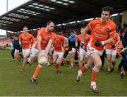 1 February 2015; Mark Shields, Ciaran McKeever and Jamie Clarke, Armagh, lead the charge as the team break away from the team photograph. Allianz Football League, Division 3, Round 1, Armagh v Tipperary. Athletic Grounds, Armagh. Picture credit: Oliver McVeigh / SPORTSFILE