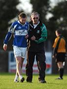 11 November 2007; Colm Parkinson is assisted by the Portlaoise manager Karl Lenihan. AIB Leinster Club Football Championship Quarter- inal, St Patrick's v Portlaoise, St. Brigid's Park, Dundalk, Co. Louth. Picture credit; Ray McManus / SPORTSFILE