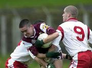 29 April 2000; Barry Dooney of Galway in action against Marte Harte and Kevin Hughes of Tyrone during the All-Ireland Under 21 Football Championship Semi-Final match between Galway and Tyrone at Páirc Seán Mac Diarmada in Carrick-On-Shannon, Leitrim. Photo by Damien Eagers/Sportsfile