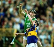 30 April 2000; Barry Foley of Limerick in action against Philip Maher of Tipperary during the Church & General National Hurling League Division 1 Semi-Final match between Tipperary and Limerick at Semple Stadium in Thurles, Tipperary. Photo by Ray McManus/Sportsfile