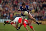 23 April 2000; Colm Parkinson of Laois is tackled by Peter McGinnity of Louth during the Church & General National Football League Division 2 Semi-Final match between Louth and Laois at Cusack Park in Mullingar, Westmeath. Photo by Aoife Rice/Sportsfile