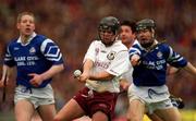 17 March 2000; David Donohue of Athenry in action against Kenneth Kennedy, left, and Darragh O'Driscoll of St Josephs Doorabarefield during the AIB All-Ireland Senior Club Hurling Championship Final match between Athenry and St Josephs Doorabarefield at Croke Park in Dublin. Photo by Ray McManus/Sportsfile