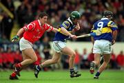 2 April 2000; David Kennedy of Tipperary in action against Fergal McCormack of Cork during the Church & General National Hurling League Division 1B match between Cork and Tipperary at Páirc Uí Chaoimh in Cork. Photo by Brendan Moran/Sportsfile