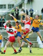 23 April 2000; Anthony Tohill of Derry in action against Donal Casserly, right, and Basil Mannion, of Roscommon during the Church & General National Football League Division 1 Semi-Final match between Derry and Roscommon at St Tiernach's Park in Clones, Monaghan. Photo by Damien Eagers/Sportsfile