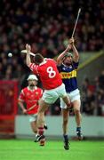 2 April 2000; Eddie Enright of Tipperary in action against Mark Landers of Cork during the Church & General National Hurling League Division 1B match between Cork and Tipperary at Páirc Uí Chaoimh in Cork. Photo by Brendan Moran/Sportsfile
