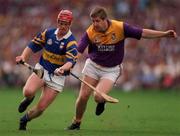 17 August 1997; Eugene O'Neill of Tipperary in action against Ger Cush of Wexford during the GAA All-Ireland Senior Hurling Championship Semi-Final match between Tipperary and Wexford at Croke Park in Dublin. Photo by Ray McManus/Sportsfile