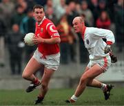 5 March 2000; Fachtna Collins of Cork in action against Gerard Reid of Armagh during the Church & General National Football League Division 1A Round 5 match between Armagh and Cork at Crossmaglen Rangers GAC Club in Armagh. Photo by Damien Eagers/Sportsfile