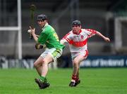 29 April 2000; John Maher of Kerry has a shot at goal despite the tackle of Benny Ward of Derry during the Church & General National Hurling League Division 1 Relegation Play-Off match between Kerry and Derry at Parnell Park in Dublin. Photo by Brendan Moran/Sportsfile