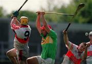 29 April 2000; Kevin O'Sullivan of Kerry in action against Michael Conway, left, and Raymond O'Hagan of Derry during the Church & General National Hurling League Division 1 Relegation Play-Off match between Kerry and Derry at Parnell Park in Dublin. Photo by Brendan Moran/Sportsfile