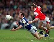 23 April 2000; Mickey Graham of Laois is tackled by James Brady of Louth during the Church & General National Football League Division 2 Semi-Final match between Louth and Laois at Cusack Park in Mullingar, Westmeath. Photo by Ray McManus/Sportsfile