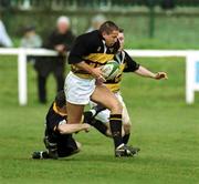 22 April 2000; Mike Lynch of Young Munster is tackled by Donal Rigney of Buccaneers during the AIB All-Ireland League Division 1 match between Young Munster and Buccaneers at Tom Clifford Park in Limerick. Photo by Ray Lohan/Sportsfile