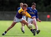 9 April 2000; Peter Reilly of Cavan in action against Leigh O'Brien of Wexford during the Church & General National Football League Division 2B Round 7 match between Wexford and Cavan at O'Kennedy Park in New Ross, Wexford. Photo by Matt Browne/Sportsfile