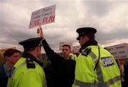 30 March 2000; A protester is kept away by the Gardai while An Taoiseach Bertie Ahern TD tossed the first sod at Shamrock Rovers new home stadium in Tallaght, Dublin. Photo by David Maher/Sportsfile