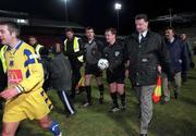 4 April 2000; Referee John McDermott is escorted off the pitch by security following the Eircom League Premier Division match between Shelbourne and Drogheda United at Tolka Park in Dublin. Photo by Brendan Moran/Sportsfile