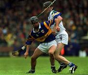 16 April 2000; Thomas Dunne of Tipperary is tackled by Tom Feeney of Waterford during the Church & General National Hurling League Division 1B Round 7 match between Waterford and Tipperary at Walsh Park in Waterford. Photo by Matt Browne/Sportsfile