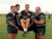 6 October 1999; Australia's Tim Horan is carried in an inflatable chair by team-mates, from left, Jason Little, John Eales and Richard Harry at a squad training session in Portmarnock after he broke the Guinness try challenge during their game against Romania. Tim scored Australia's first try in under 119.5 seconds, the time it takes to pour the perfect pint of Guinness. As a result, Tim received a year's supply of Guinness and there was a £10,000 donation to the charity of Tim's choice. Photo by Brendan Moran/Sportsfile