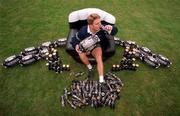6 October 1999; Australia's Tim Horan sits in an inflatable chair at a squad training session in Portmarnock after he broke the Guinness try challenge during their game against Romania. Tim scored Australia's first try in under 119.5 seconds, the time it takes to pour the perfect pint of Guinness. As a result, Tim received a year's supply of Guinness and there was a £10,000 donation to the charity of Tim's choice. Photo by Brendan Moran/Sportsfile