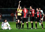 2 December 2007; Referee David McKeon issues Kevin Dohery, Longford Town, with a yellow card as team-mate's Damien Brennan, 4, and Pat Sullivan remonstrate and Denis Behan, Cork City, watches on from the ground. FAI Ford Cup Final, Cork City v Longford Town, RDS, Ballsbridge, Dublin. Picture credit; Stephen McCarthy / SPORTSFILE