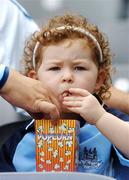 15 July 2007; Young Dublin supporter Molly Tresson, age 3, eats some popcorn as her father Sean, originally from Dublin but living in Wexford, takes some for himself, before the game. Bank of Ireland Leinster Senior Football Championship Final, Dublin v Laois, Croke Park, Dublin. Picture by; Brendan Moran / SPORTSFILE