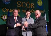 14 February 2015; Proinsias Ó Cathasaigh, Lios Póil, Co. Kerry, is presented with his trophy by Uachtaran Cumann Luthcleas Gael Liam O Neill, left, and Liam O Laochdha, Cathaoirleach, Coiste Naisiunta Scor, right, after winning the Solo Singing competition during the All-Ireland Scór na nÓg Championship Finals 2015. Citywest Hotel, Saggart, Co. Dublin. Picture credit: Pat Murphy / SPORTSFILE