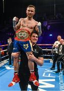 28 February 2015; Carl Frampton is held aloft by trainer Shane McGuigan after a fifth round stoppage against Chris Avalos during their IBF Super-Bantamweight World Title fight. The World is Not Enough, Odyssey Arena, Belfast, Co. Antrim. Picture credit: Ramsey Cardy / SPORTSFILE