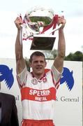 20 May 2000; Derry captain Anthony Tohill lifts the trophy following his side's victory during the Church & General National Football League Final Replay match between Derry and Meath at St Tiernach's Park in Clones, Monaghan. Photo by David Maher/Sportsfile