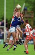 14 May 2000; Dermot Heaney of Derry in action against Cathal Collins and Peter Reilly of Cavan during the Bank of Ireland Ulster Senior Football Championship Quarter-Final match between Cavan and Derry at Breffni Park in Cavan. Photo by Ray Lohan/Sportsfile