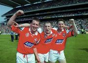 7 May 2000; Louth players, from left, Mark Stanfield, Christy Grimes and John McGrane celebrate following their side's victory during the Church & General National Football League Division 2 Final match between Louth and Offaly at Croke Park in Dublin. Photo by Ray McManus/Sportsfile