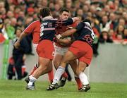 15 April 2000; David Wallace of Munster is tackled by Fabrice Landreau, left, and Richard Pool Jones of Stade Francais during the Heineken Cup Quarter-Final match between Munster and Stade Francais at Thomond Park in Limerick. Photo by Brendan Moran/Sportsfile