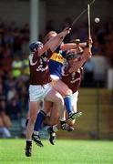 14 May 2000; Declan Ryan of Tipperary in action against Liam Hodgins, left, and Cathal Moore of Galway during the Church & General National Hurling League Final match between Tipperary and Galway at the Gaelic Grounds in Limerick. Photo by Brendan Moran/Sportsfile