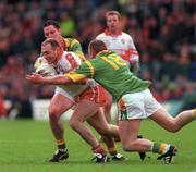 20 May 2000; Henry Downey of Derry in action against Tommy Dowd, front, and Ronan Fitzsimons of Meath during the Church & General National Football League Final Replay match between Derry and Meath at St Tiernach's Park in Clones, Monaghan. Photo by Aoife Rice/Sportsfile