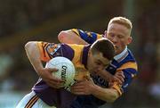 20 May 2000; Jason Lawlor of Wexford is tackled by Shay Nolan of Wicklow during the Bank of Ireland Leinster Senior Football Championship Group Stage Round 3 match between Wicklow and Wexford at Aughrim County Ground in Aughrim, Wicklow. Photo by Matt Browne/Sportsfile