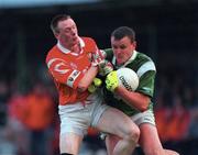 20 May 2000; Jason Stokes of Limerick in action against Philip Clifford of Cork during the Bank of Ireland Munster Senior Football Championship Quarter-Final match between Limerick and Cork at Fitzgerald Park in Kilmallock, Limerick. Photo by Damien Eagers/Sportsfile