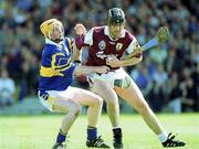 14 May 2000; Joe Rabbitte of Galway in action against Eamonn Corcoran of Tipperary during the Church & General National Hurling League Final match between Tipperary and Galway at the Gaelic Grounds in Limerick. Photo by Brendan Moran/Sportsfile