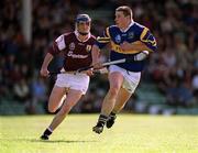 14 May 2000;  John Carroll of Tipperary in action against Mark Kerins of Galway during the Church & General National Hurling League Final match between Tipperary and Galway at the Gaelic Grounds in Limerick. Photo by Brendan Moran/Sportsfile