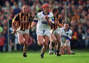 12 March 2000; Johnny Brenner of Waterford  races clear of Andy Comerford, left, and John Paul Corcoran of Kilkenny during the Church & General National Hurling League Division 1B match between Kilkenny and Waterford at Nowlan Park in Kilkenny. Photo by Ray McManus/Sportsfile