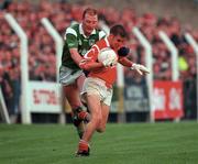 20 May 2000; Kieran Daly of Cork in action against John Quane of Limerick during the Bank of Ireland Munster Senior Football Championship Quarter-Final match between Limerick and Cork at Fitzgerald Park in Kilmallock, Limerick. Photo by Damien Eagers/Sportsfile
