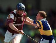 14 May 2000; Liam Hodgins of Galway in action against Ger Maguire of Tipperary during the Church & General National Hurling League Final match between Tipperary and Galway at the Gaelic Grounds in Limerick. Photo by Brendan Moran/Sportsfile