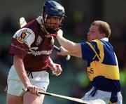 14 May 2000; Liam Hodgins of Galway in action against Ger Maguire of Tipperary during the Church & General National Hurling League Final match between Tipperary and Galway at the Gaelic Grounds in Limerick. Photo by Brendan Moran/Sportsfile