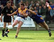 20 May 2000; Michael Mahon of Wexford takes a shot under pressure from Barry O'Donovan of Wicklow during the Bank of Ireland Leinster Senior Football Championship Group Stage Round 3 match between Wicklow and Wexford at Aughrim County Ground in Aughrim, Wicklow. Photo by Matt Browne/Sportsfile