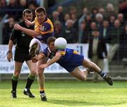 20 May 2000; Michael Mahon of Wexford takes a shot under pressure from Barry O'Donovan of Wicklow during the Bank of Ireland Leinster Senior Football Championship Group Stage Round 3 match between Wicklow and Wexford at Aughrim County Ground in Aughrim, Wicklow. Photo by Matt Browne/Sportsfile