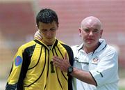 3 May 2000; Wayne Henderson of Republic of Ireland is consoled by assistant coach Noel O'Reilly following their side's defeat during the UEFA U16 European Championship Finals match between Russia and Republic of Ireland at Be'er Sheva Municipal Stadium in Be'er Sheva, Israel. Photo by David Maher/Sportsfile