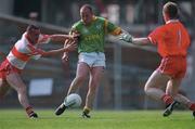 7 May 2000; Ollie Murphy, of Meath shoots to score his side's only goal, despite pressure from Gary Coleman, left, and Eoin McCluskey of Derry during the Church & General National Football League Final between Derry and Meath at Croke Park in Dublin. Photo by Ray McManus/Sportsfile
