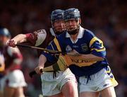 14 May 2000; Paddy O'Brien of Tipperary in action against Liam Hodgins of Galway during the Church & General National Hurling League Final match between Tipperary and Galway at the Gaelic Grounds in Limerick. Photo by Brendan Moran/Sportsfile