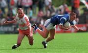 14 May 2000; Paul Galligan of Cavan in action against Henry Downey of Derry during the Bank of Ireland Ulster Senior Football Championship Quarter-Final match between Cavan and Derry at Breffni Park in Cavan. Photo by David Maher/Sportsfile